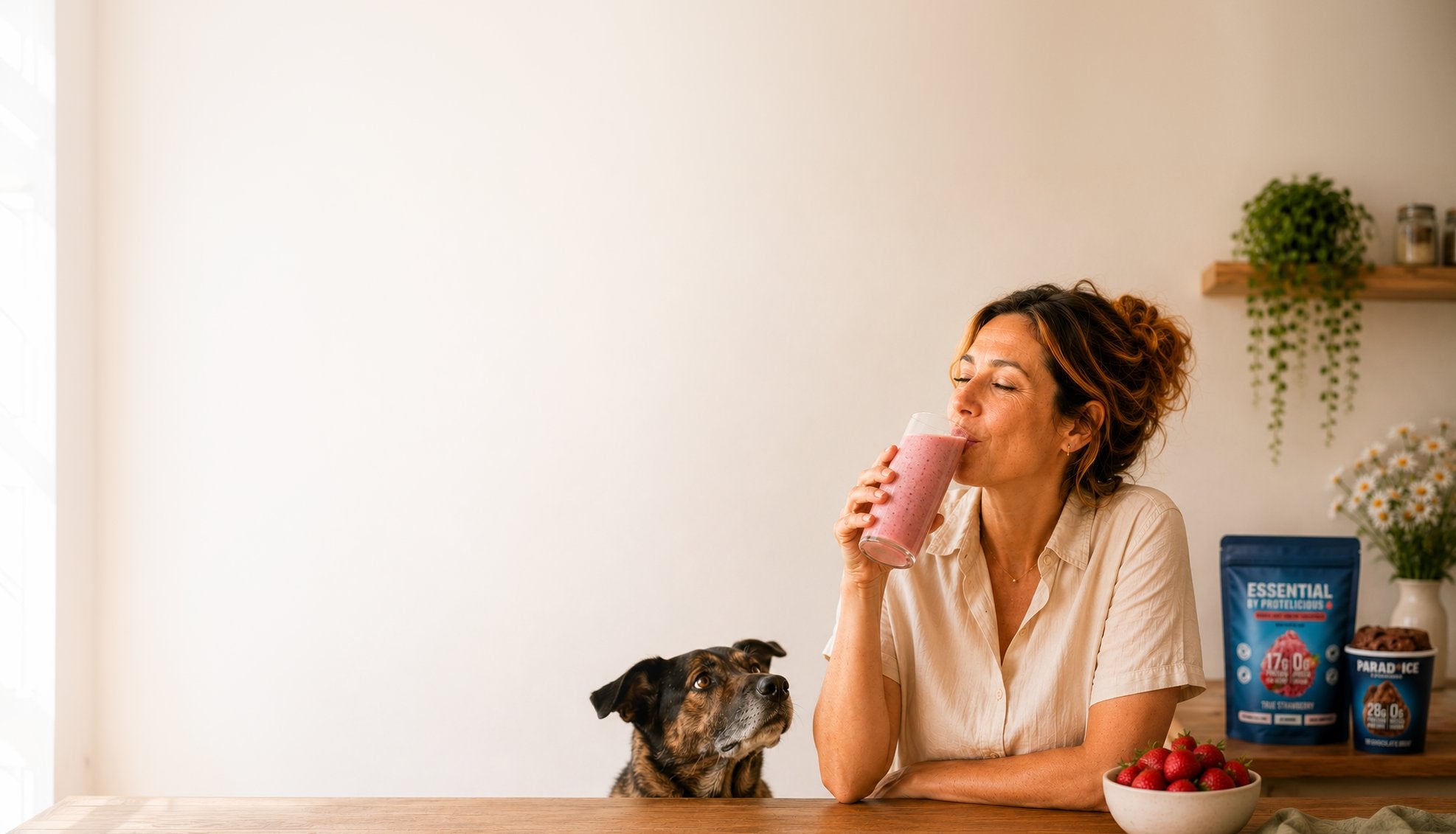 Protelicious — French gourmet protein: woman enjoying a strawberry smoothie at home