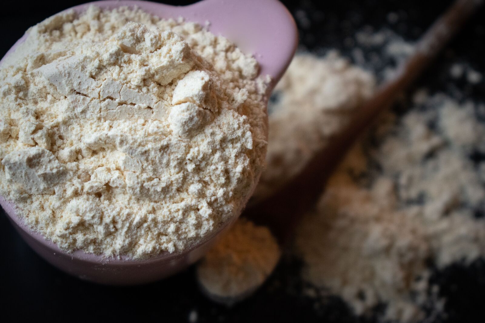 Whey protein powder in a scoop